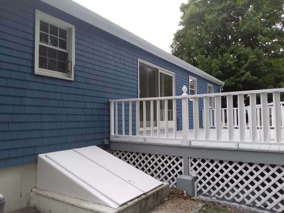 Deck painting in RI: white deck railings and lattice on a Genesis Painting job