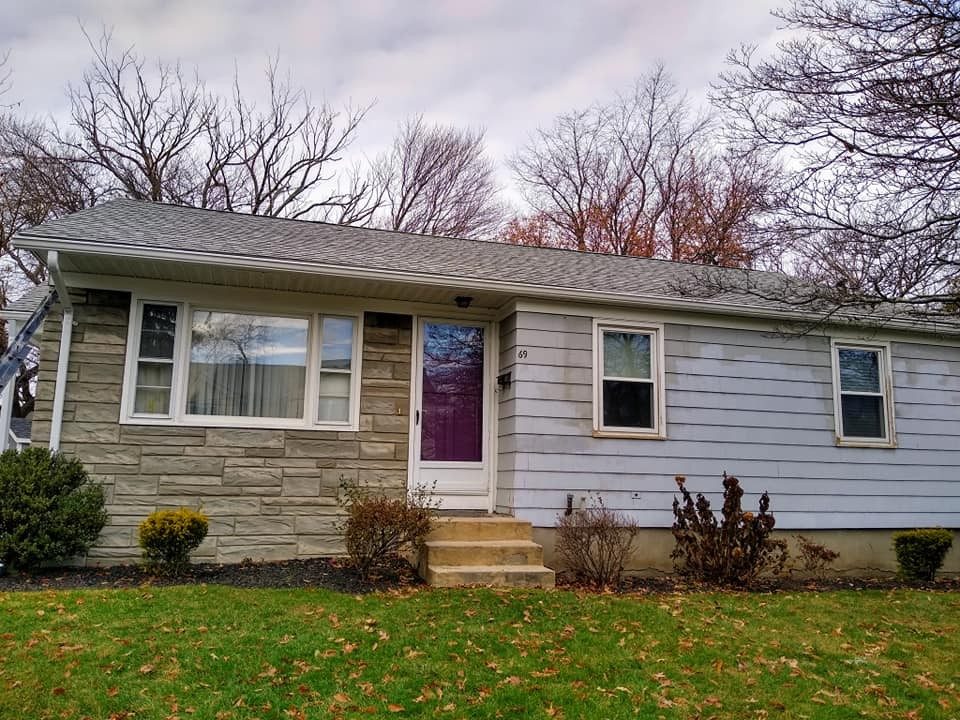 Exterior repaint of a ranch home with white trim