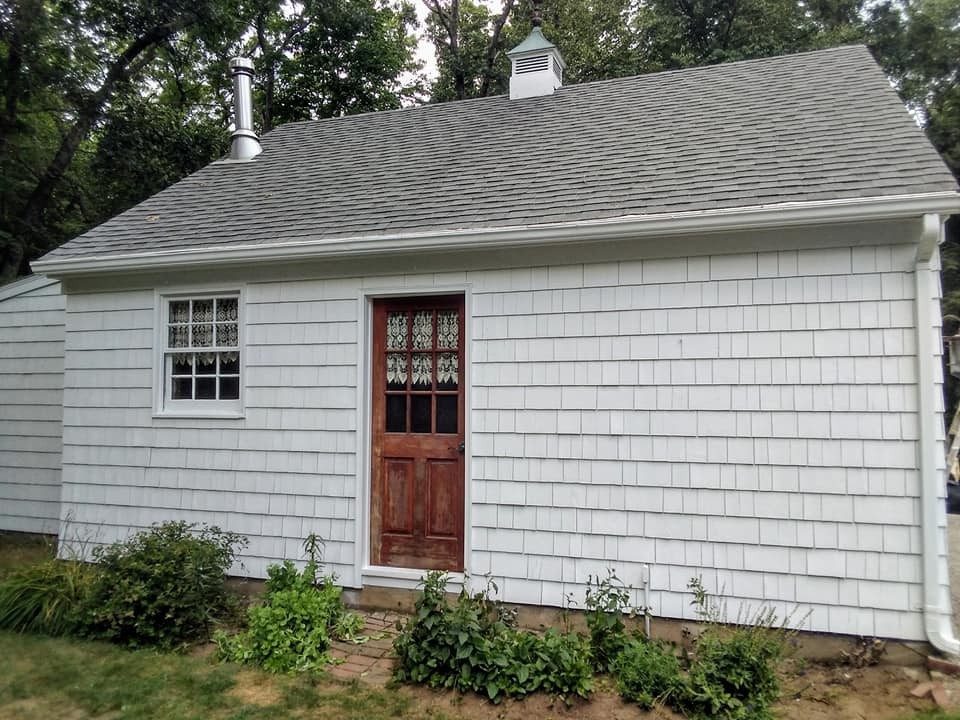 Rhode Island home roofline and gutters serviced by Genesis Painting